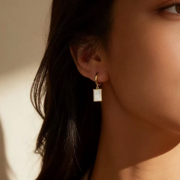 gold-square-white-mother-of-pearl-huggie-drop-earring-worn-on-ear