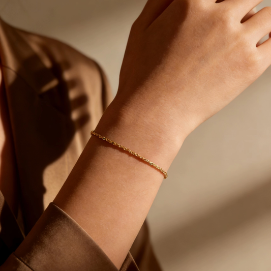 Gold twist rope chain bracelet worn on wrist, minimalist gold plated chain jewelry for women