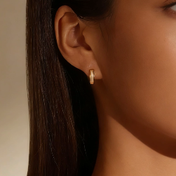 Gold white mother-of-pearl huggie hoop earring worn on ear, minimalist small hoop jewelry for women