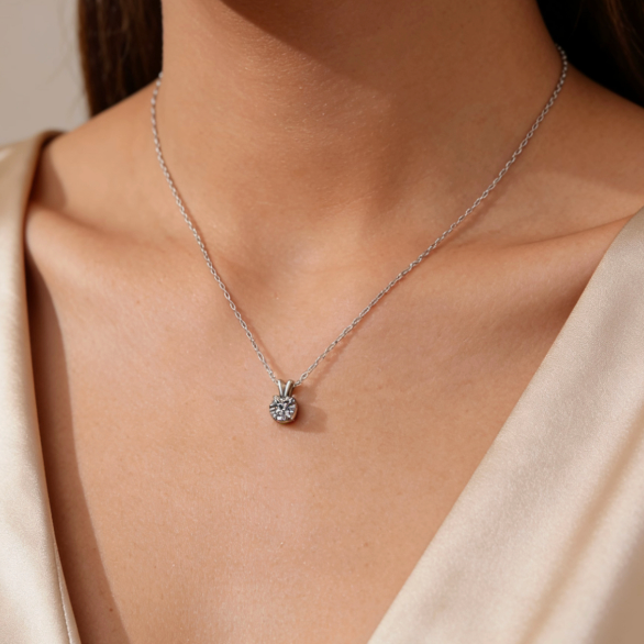 Silver 4-prong moissanite solitaire pendant necklace worn on neck, minimalist mini moissanite jewelry for women