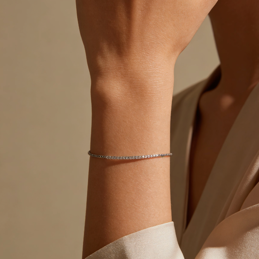 Silver crystal tennis bracelet worn on wrist, minimalist full pavé jewelry for women