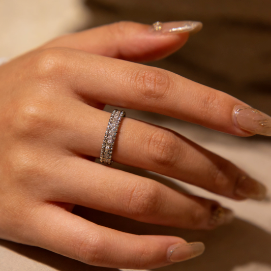 Silver double row pave moissanite eternity band ring worn on finger, minimalist dainty moissanite stacking jewelry for women