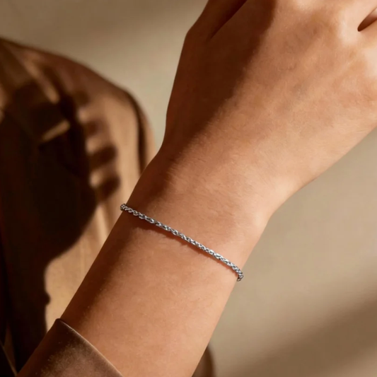 Silver twist rope chain bracelet worn on wrist, minimalist shiny twist chain jewelry for women