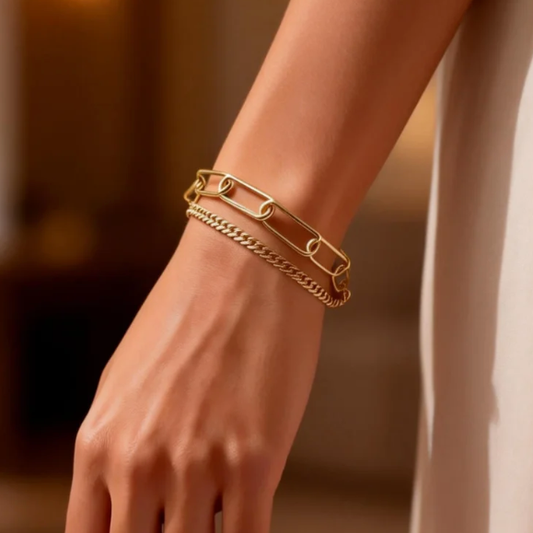 Gold double layer paperclip and cuban chain bracelet worn on wrist, minimalist layered jewelry for women