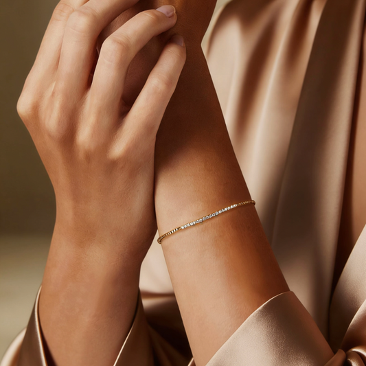 Gold half pavé crystal tennis bracelet worn on wrist, minimalist half stone jewelry for women