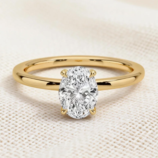 Gold oval moissanite four-prong solitaire ring, minimalist engagement jewelry for women