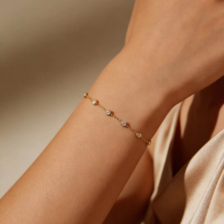 Gold round crystal by-the-yard bracelet worn on wrist, minimalist station chain jewelry for women