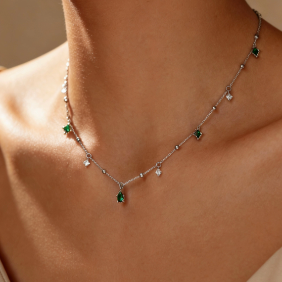 Silver emerald gemstone teardrop station necklace worn on neck, minimalist square emerald and crystal charm jewelry for women