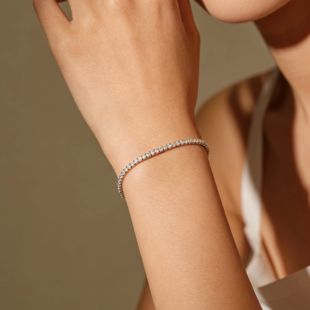 Silver full pavé moissanite tennis bracelet worn on wrist, minimalist full stone jewelry for women