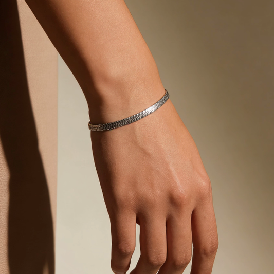 Silver herringbone chain bracelet worn on wrist, minimalist textured flat snake chain jewelry for women