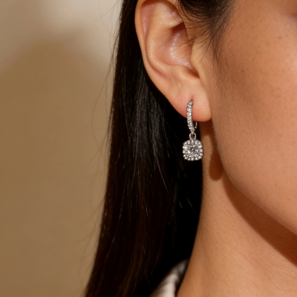 Silver mini halo moissanite cushion drop hoop earrings worn on ear, minimalist dainty moissanite layering jewelry for women