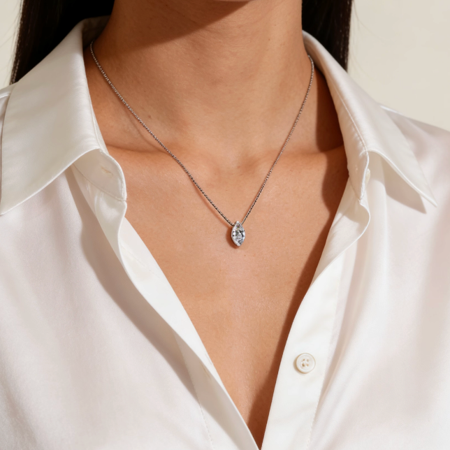 Silver mini marquise cut moissanite solitaire pendant necklace worn on neck, minimalist dainty moissanite layering jewelry for women