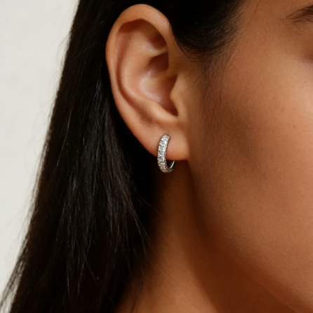 Silver mini three-row pave moissanite hoop earrings worn on ear, minimalist dainty moissanite layering jewelry for women