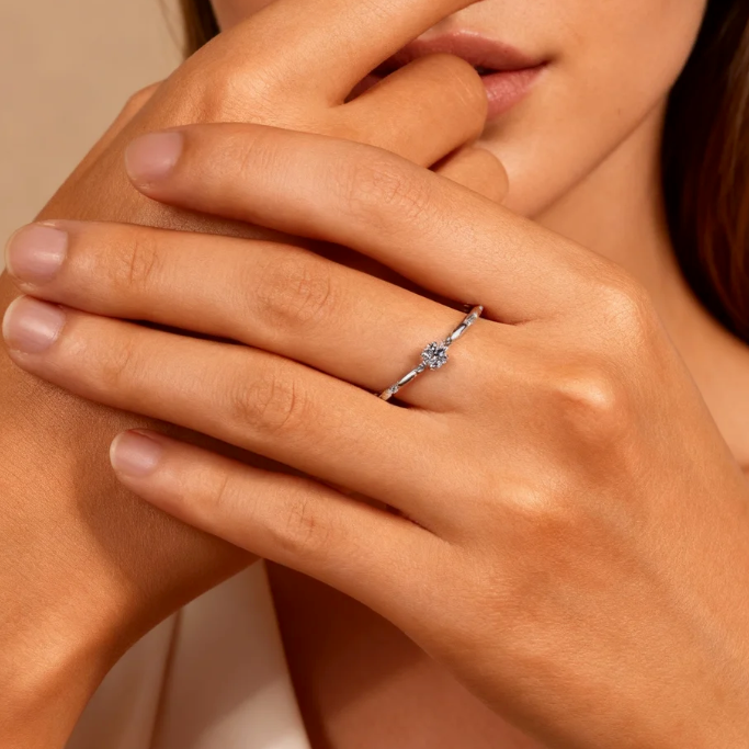 Silver thin band solitaire moissanite ring worn on finger, minimalist stackable jewelry for women