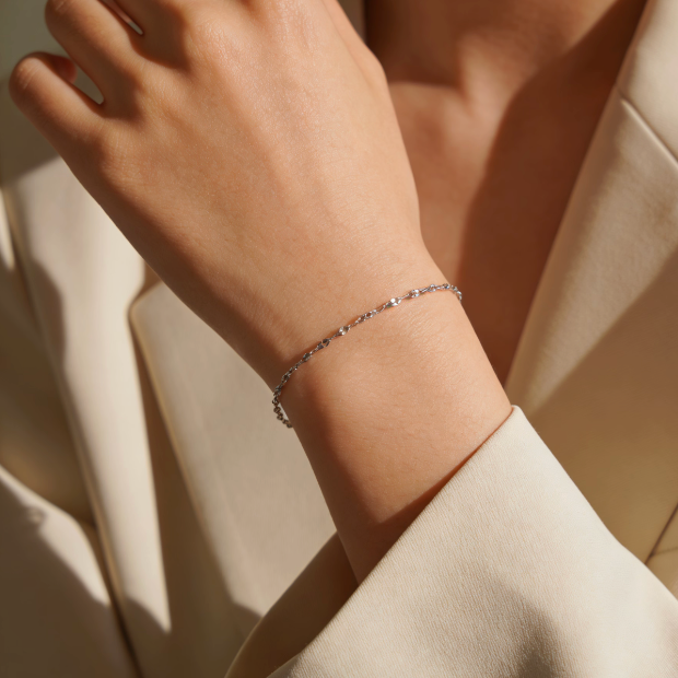 Silver tiny square sequin bracelet worn on wrist, minimalist shimmering square disc jewelry for women