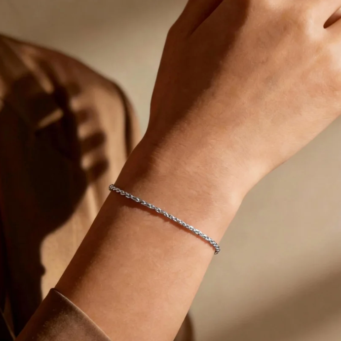 Silver twist rope chain bracelet worn on wrist, minimalist shiny twist chain jewelry for women